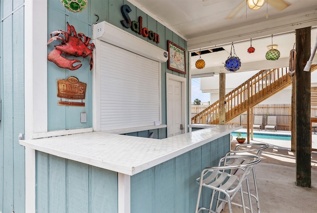 kitchen featuring a breakfast bar and a ceiling fan