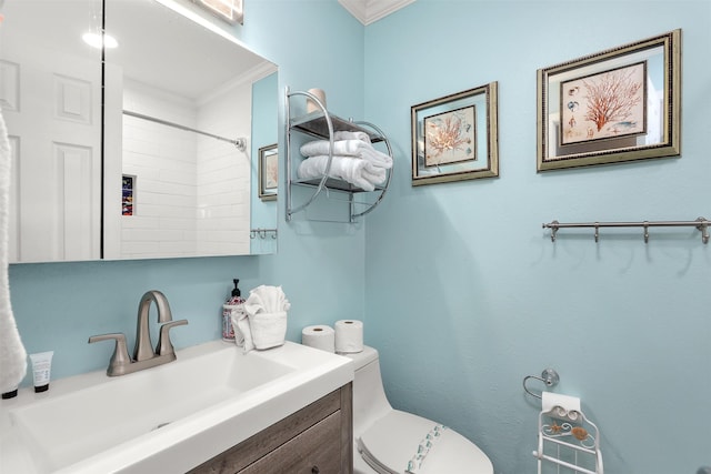 bathroom featuring crown molding, vanity, toilet, and walk in shower