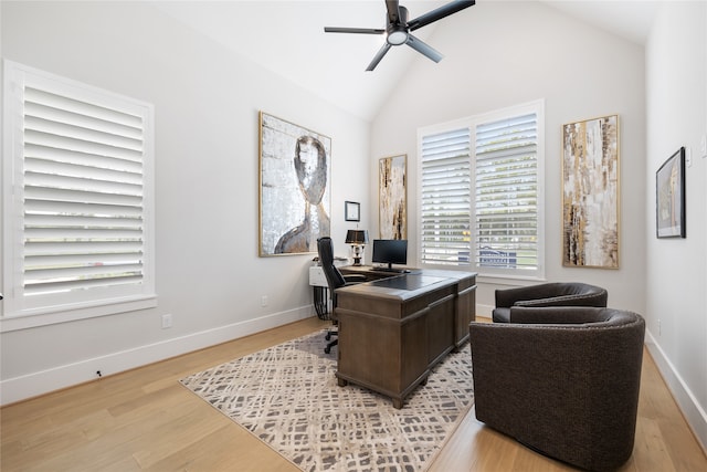 home office with high vaulted ceiling, light hardwood / wood-style floors, and ceiling fan