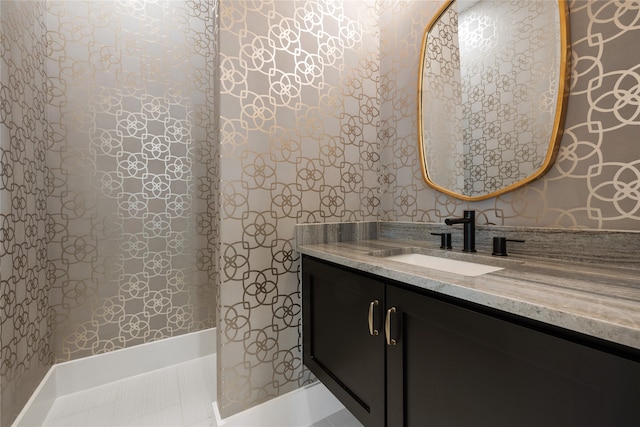 bathroom with tile patterned floors and vanity