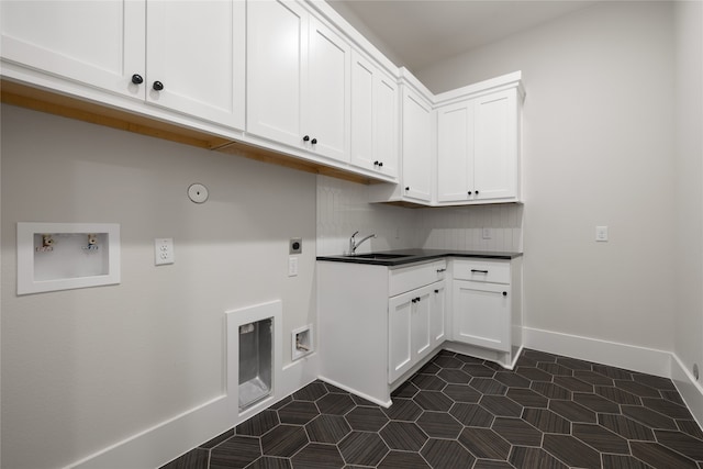 clothes washing area featuring sink, hookup for a gas dryer, cabinets, hookup for a washing machine, and electric dryer hookup