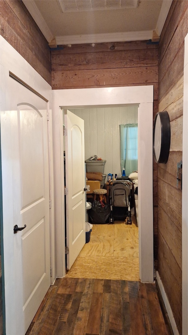 hallway with wood walls and hardwood / wood-style flooring