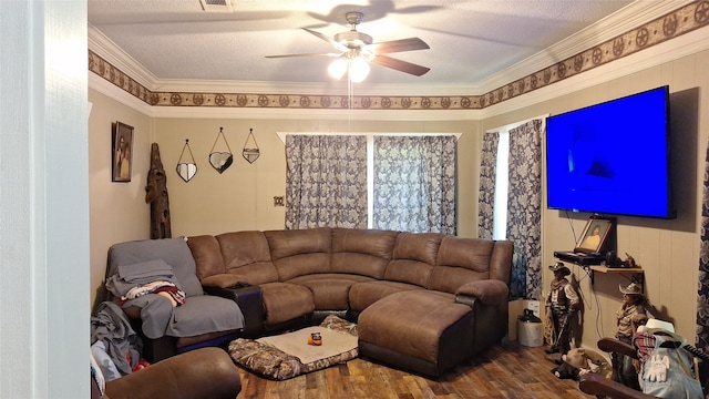 living room featuring ceiling fan, crown molding, hardwood / wood-style flooring, and a textured ceiling