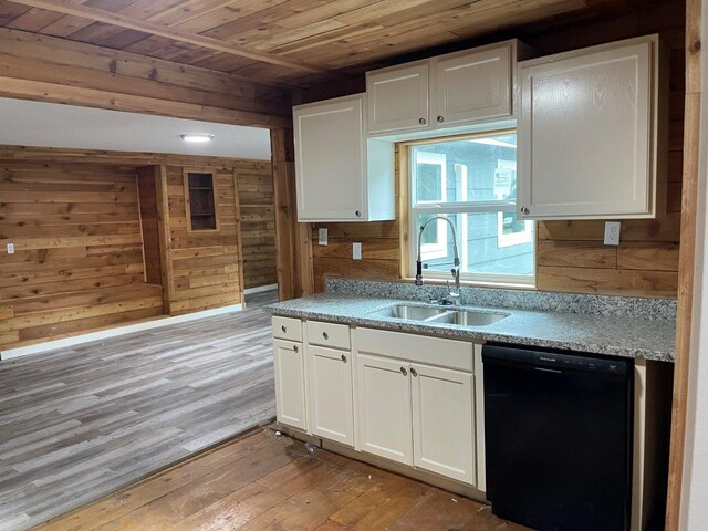 kitchen featuring black dishwasher, sink, hardwood / wood-style floors, and white cabinets