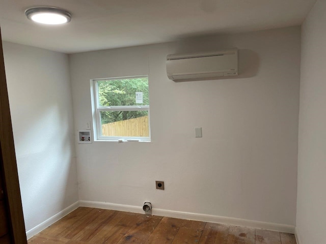 laundry area featuring hardwood / wood-style floors, a wall mounted AC, hookup for an electric dryer, and hookup for a washing machine