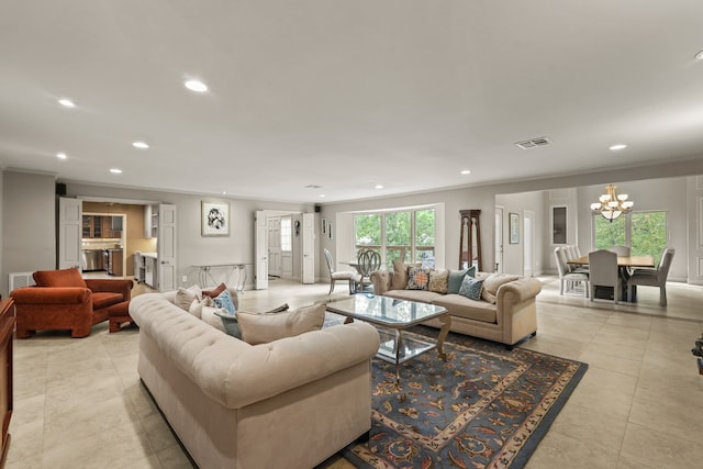 tiled living room with crown molding and a notable chandelier