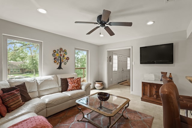 living room with light tile patterned floors and ceiling fan