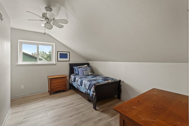 bedroom featuring light wood-type flooring, ceiling fan, and lofted ceiling