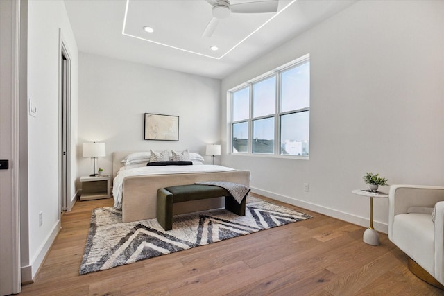 bedroom with light wood-type flooring and ceiling fan