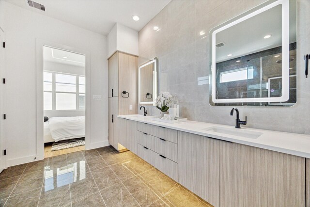 bathroom featuring tile walls, vanity, and walk in shower