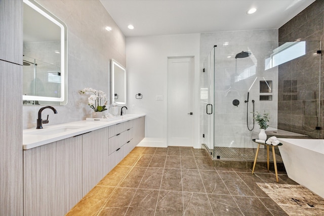 bathroom with a shower with door and vanity