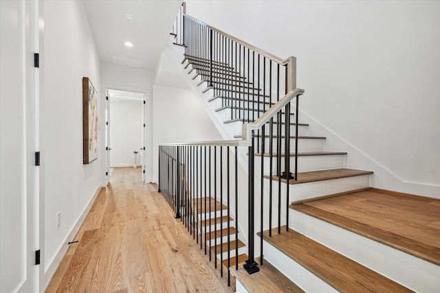 stairway featuring hardwood / wood-style flooring