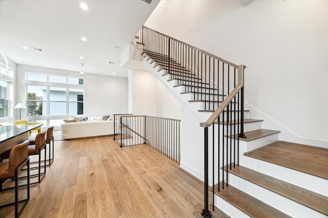 staircase with hardwood / wood-style floors