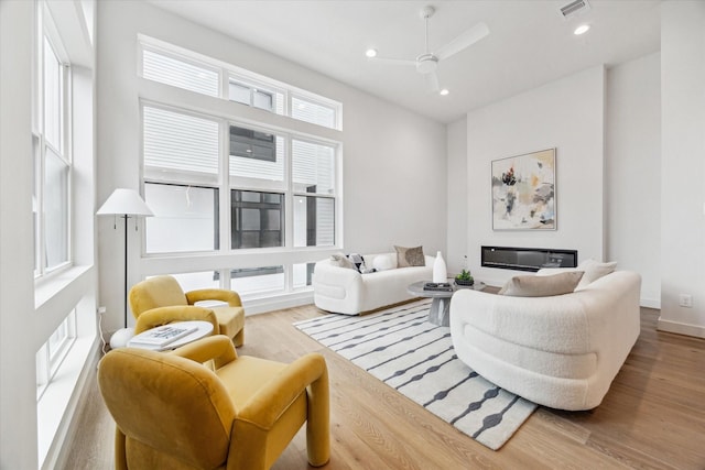 living room with ceiling fan and light hardwood / wood-style floors