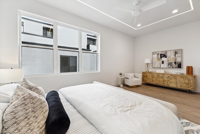 bedroom with hardwood / wood-style floors and ceiling fan