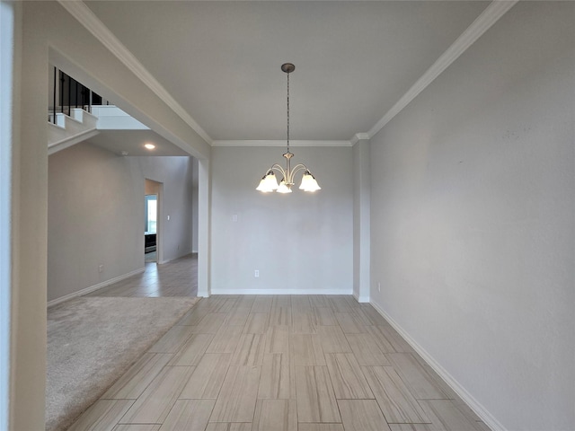 empty room with crown molding, a chandelier, and light wood-type flooring