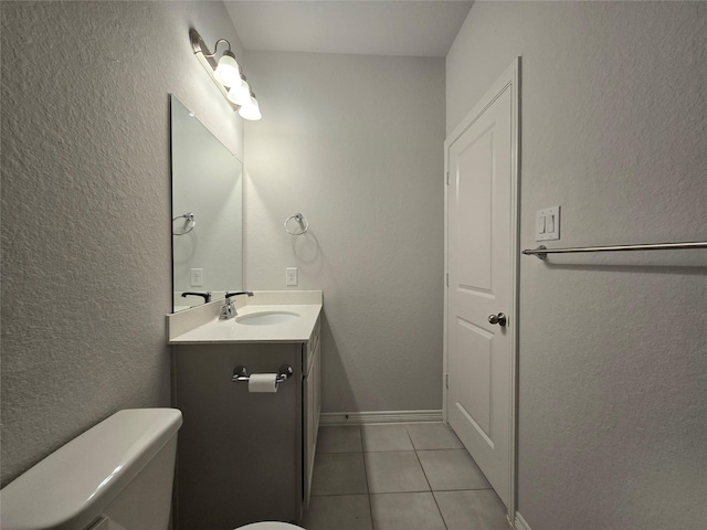 bathroom featuring tile patterned flooring, vanity, and toilet