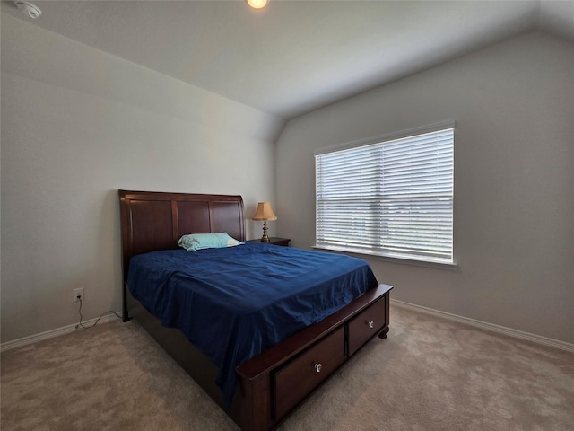 carpeted bedroom featuring vaulted ceiling