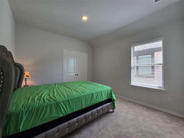 bedroom featuring vaulted ceiling and carpet flooring