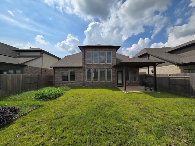 back of property with a patio and a yard