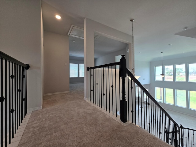 hall with light carpet and plenty of natural light