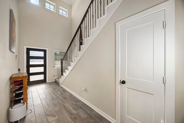 foyer entrance with a towering ceiling and hardwood / wood-style flooring