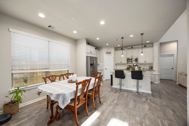 dining space with light wood-type flooring