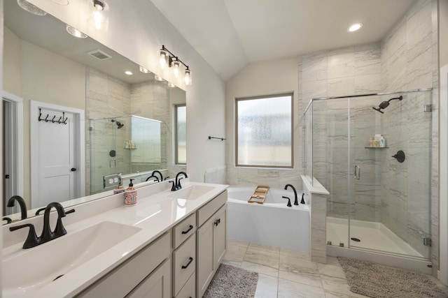 bathroom with tile patterned floors, dual bowl vanity, separate shower and tub, and lofted ceiling