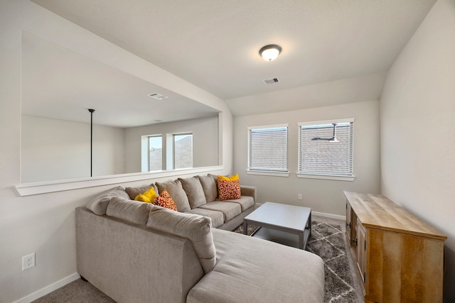 living room with dark colored carpet