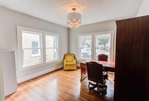 office space with a chandelier and wood-type flooring