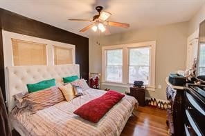 bedroom featuring ceiling fan and dark hardwood / wood-style flooring