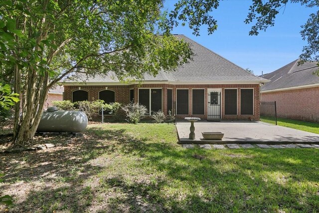 rear view of property with a lawn