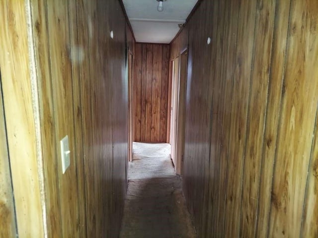 corridor featuring wooden walls