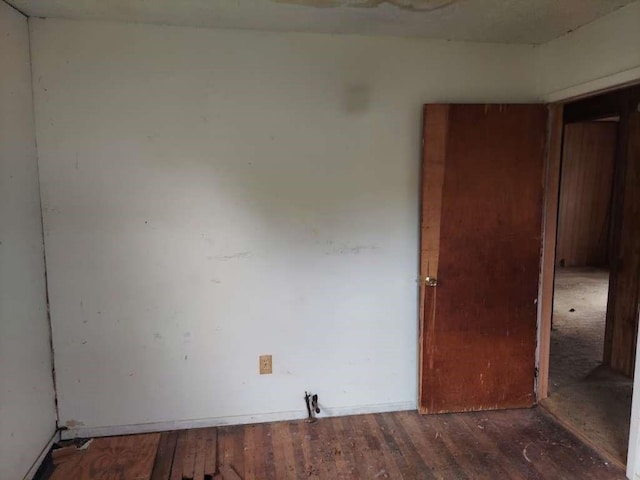 empty room featuring dark hardwood / wood-style flooring