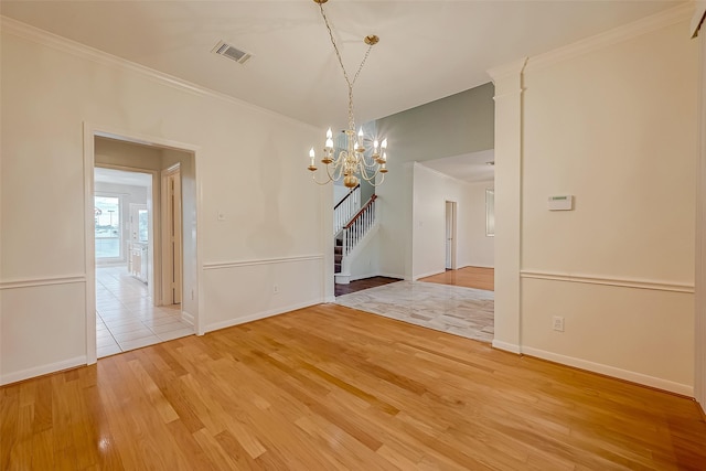 unfurnished dining area with light hardwood / wood-style flooring, a notable chandelier, and crown molding