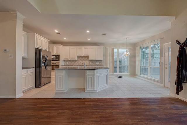 kitchen with light hardwood / wood-style flooring, white cabinets, and appliances with stainless steel finishes