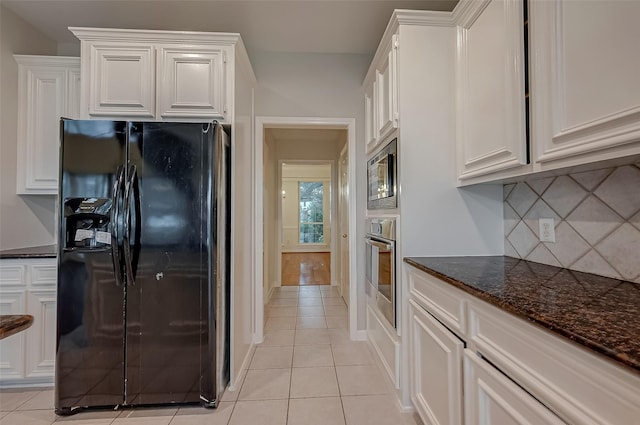 kitchen with white cabinets, appliances with stainless steel finishes, and light tile patterned floors