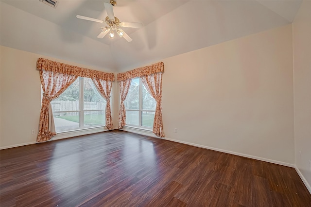 spare room featuring ceiling fan, dark hardwood / wood-style flooring, and vaulted ceiling