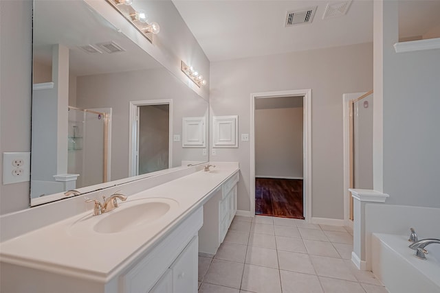 bathroom featuring tile patterned floors, separate shower and tub, and vanity