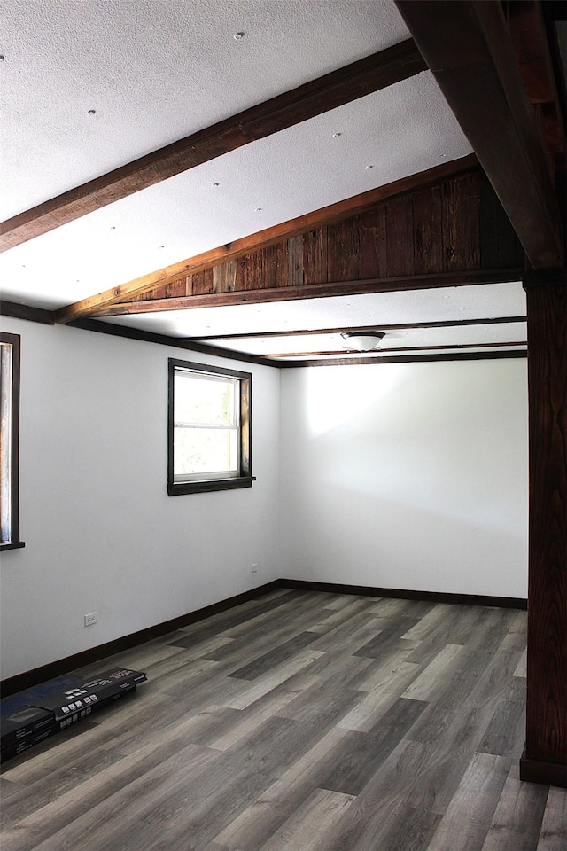 bonus room with vaulted ceiling with beams, wood-type flooring, and a textured ceiling