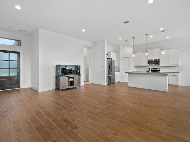 unfurnished living room featuring light wood-type flooring