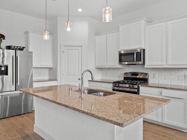 kitchen featuring sink, tasteful backsplash, light wood-type flooring, and stainless steel appliances