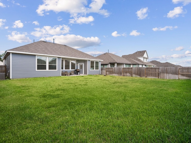 rear view of house featuring a patio area and a lawn