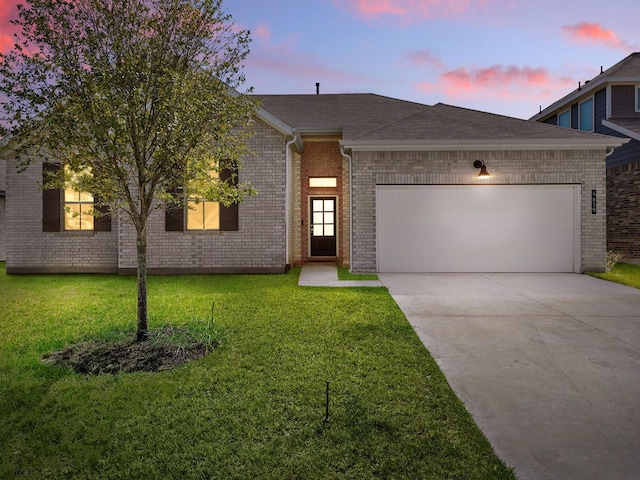 view of front facade with a garage and a yard