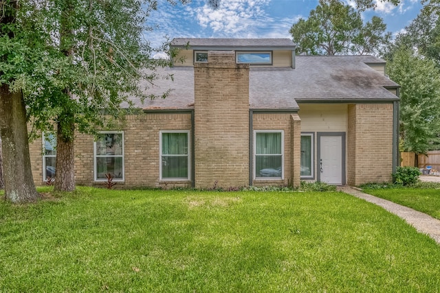 back of property featuring a yard