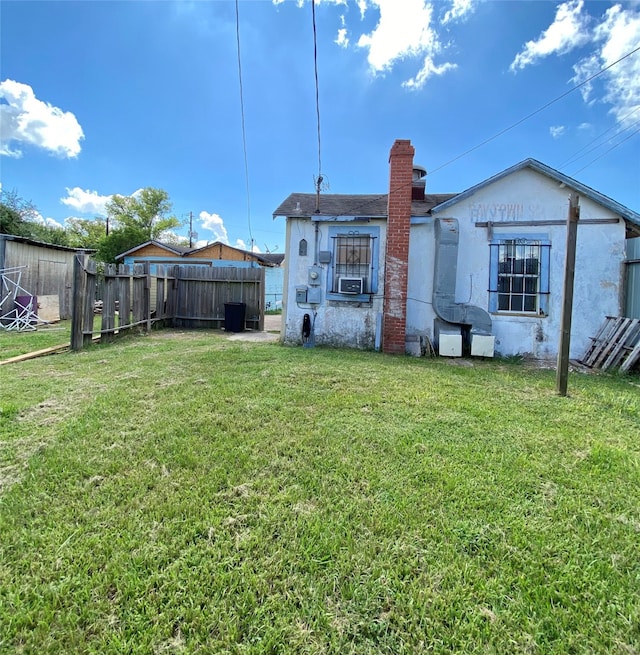 back of house with a yard