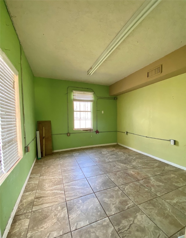 empty room with tile patterned floors