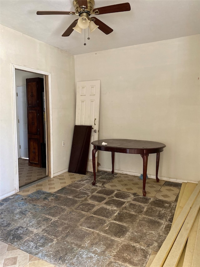 interior space with ceiling fan and tile patterned floors