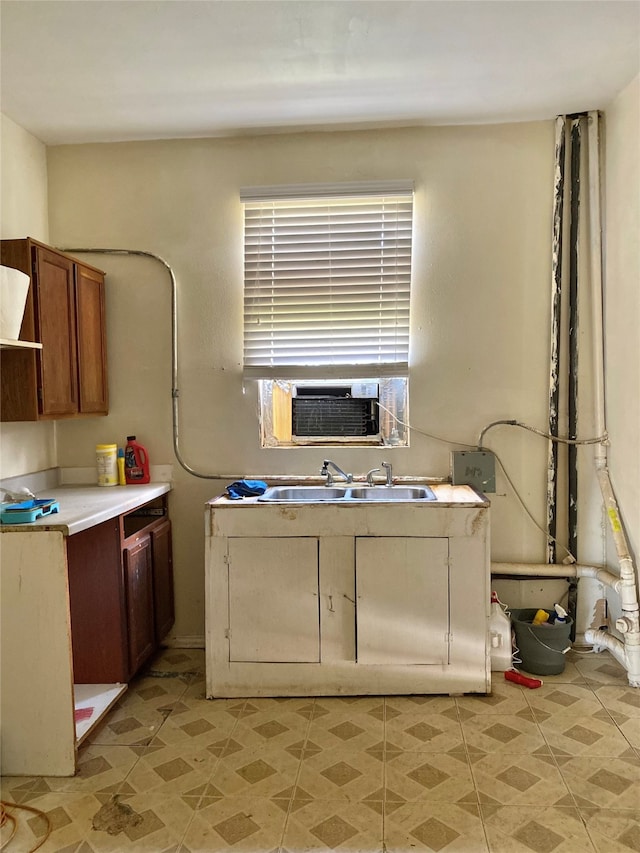 kitchen featuring sink, cooling unit, and light tile patterned floors