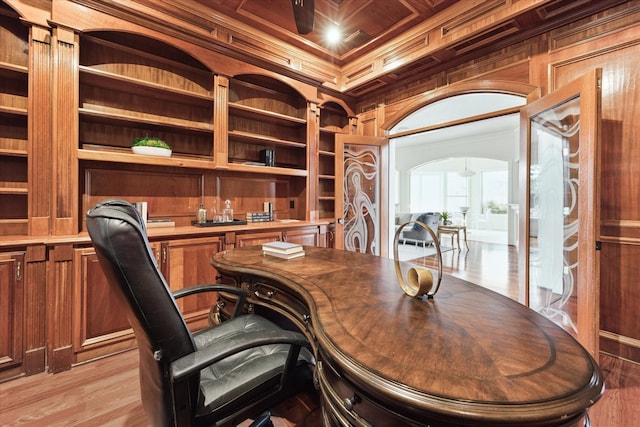 office area with beamed ceiling, light hardwood / wood-style flooring, ornamental molding, and coffered ceiling